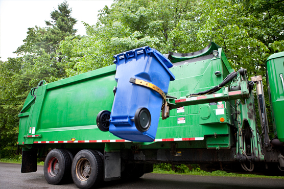 Garbage truck picking up garbage can