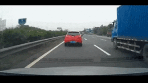 First person point of view of driving in traffic on a highway, when all of a sudden the red car in front swerves to the right, revealing a stopped car. The video ends with the driver slamming into the back of the stopped car.