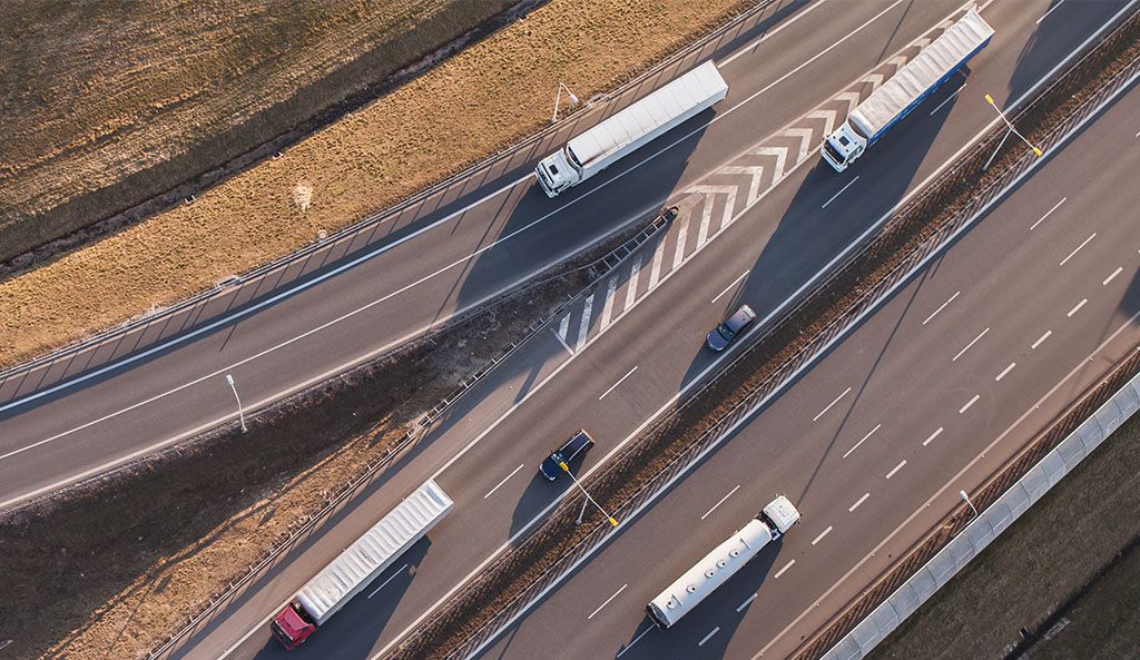 Overhead view of semi trucks driving on a highway