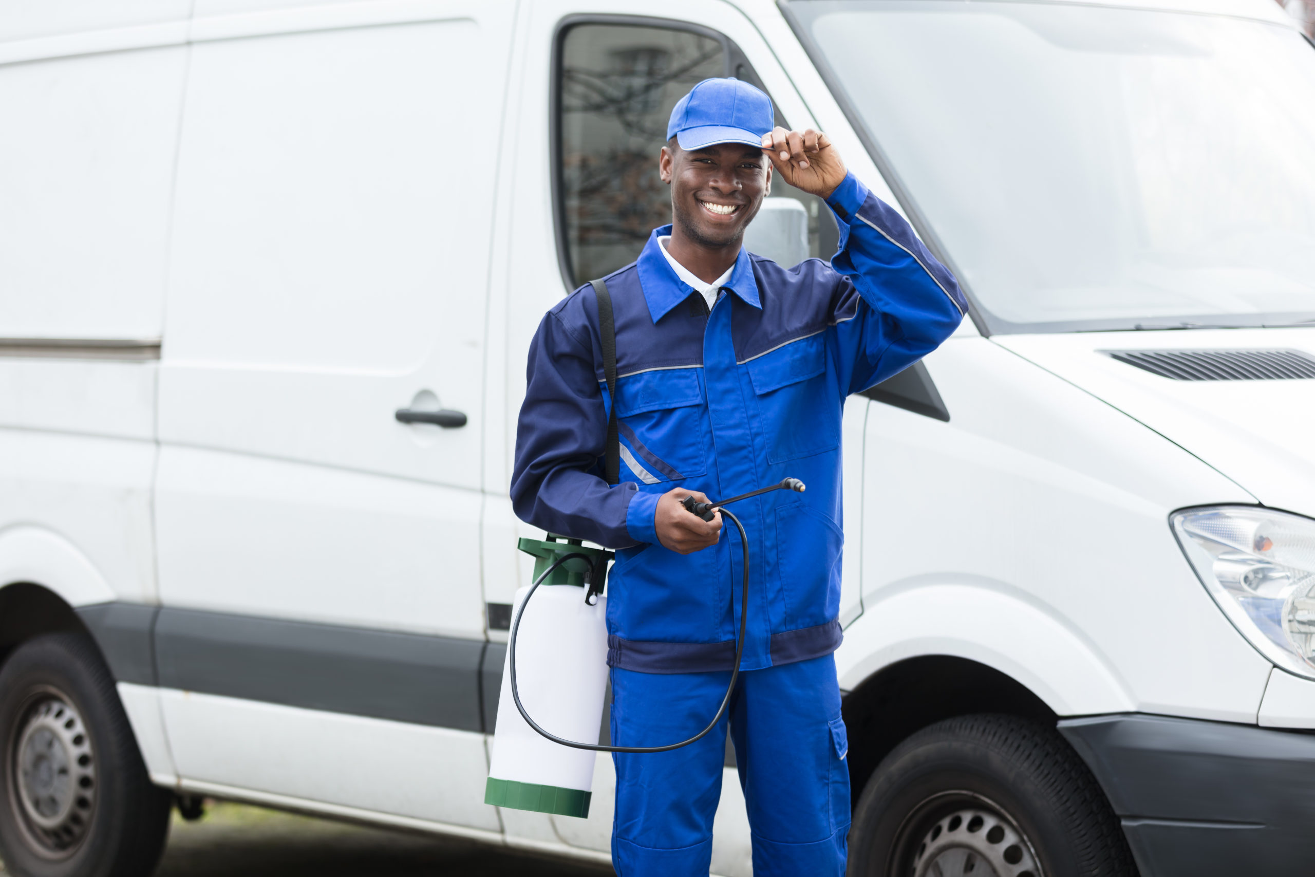 Young Smiling Male Worker With Pesticide Sprayer